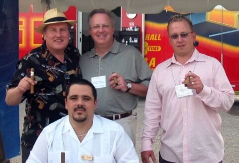 Joe and Jorge with a golfer under the event tent