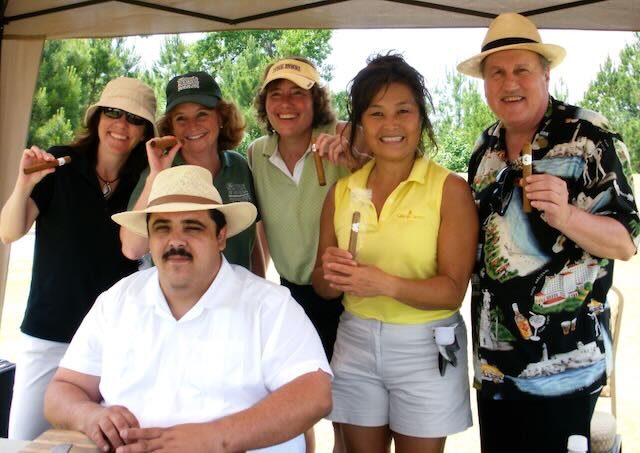 Golfers holding cigars from Joe's tent
