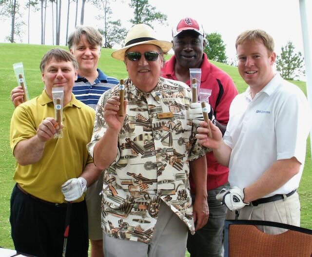 Golfers holding cigars from Joe's tent