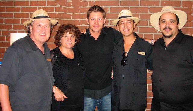 Joe with guests at a trade show display