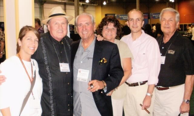 A group discussing cigars at a trade show