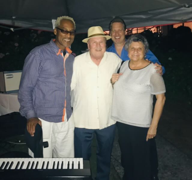Joe, Elaine, and guests at an outdoor evening event