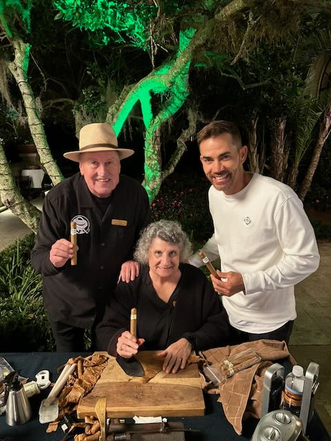Joe and Elaine with a guest at an evening garden event