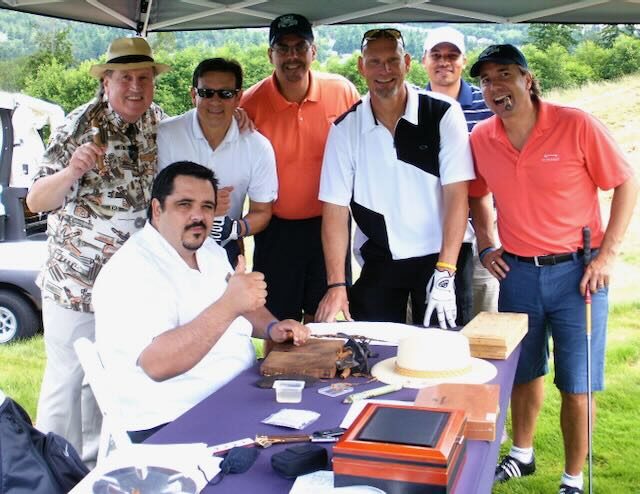 Joe with golfers under the event tent